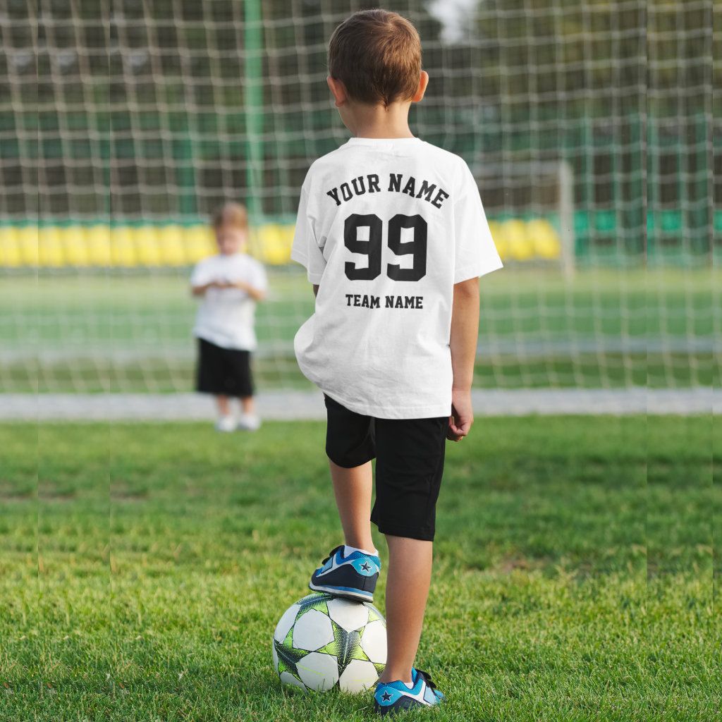 White kids T shirt personalised with a name, number, and team name on the back